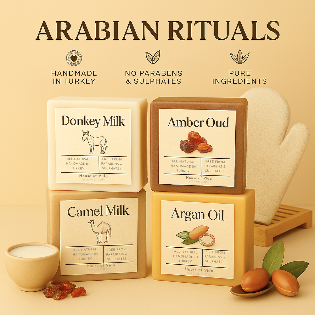 Collection of soap bars with labels for 'Donkey Milk', 'Amber Oud', 'Camel Milk', and 'Argan Oil' from Arabian Rituals on a beige background.