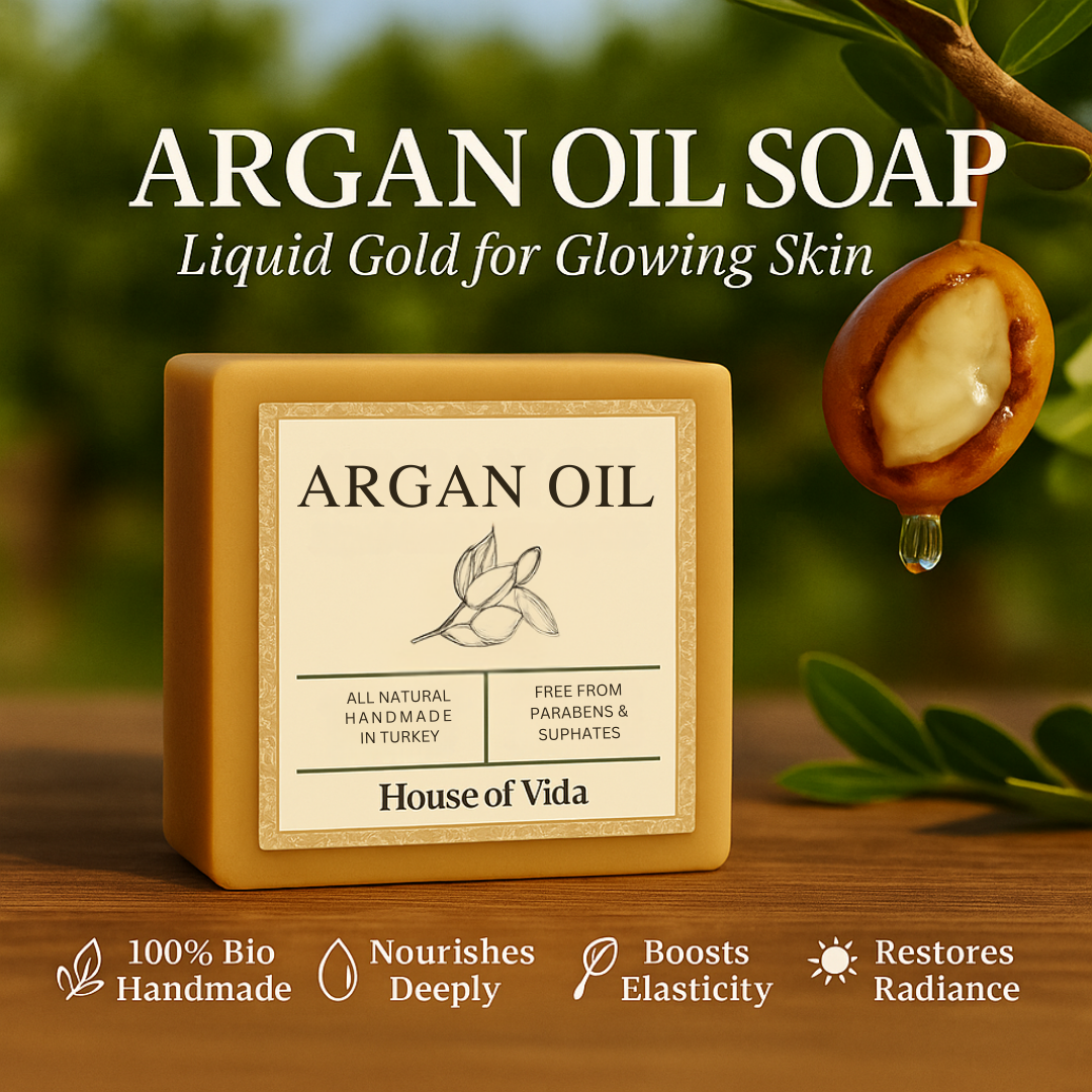 Argan oil soap with a label on a wooden surface, surrounded by argan oil seeds and leaves.