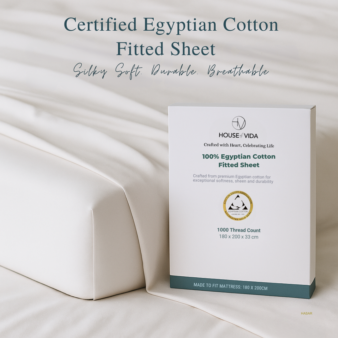 House Vida Egyptian Cotton fitted sheet packaging on a bed with text about the product's features.