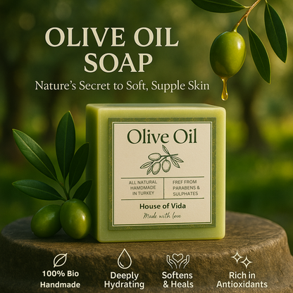Olive Oil soap with olive leaves on a wooden surface and green background