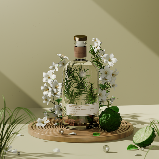 Lush Green Reed Diffuser – 1L bottle surrounded by white blossoms, green botanicals, and lime on a wooden tray, styled in a sunlit, elegant setting.