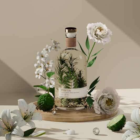 White Lily Reed Diffuser – 1L bottle styled with white lily petals, green leaves, and soft light in a serene, elegant setting.